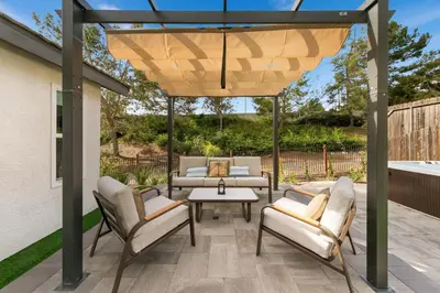 a patio with chairs and a table under a pergola at Good Vibes Cottage - Carlsbad-Vista-San Diego-Beach-Legoland in Vista