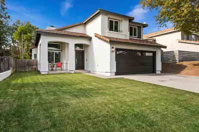 a white house with a large yard at Good Vibes Cottage - Carlsbad-Vista-San Diego-Beach-Legoland in Vista
