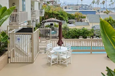 a balcony with a table and chairs and a gazebo at Oceanside Beach Condos in Oceanside