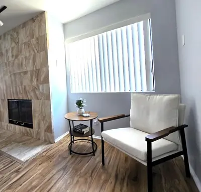 a living room with a chair and a table at San Diego Fun-Gameroom & Gazebo-Centrally Located! in San Diego