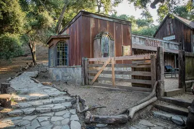 an old barn with a gate and a fence at Historic Farmhouse on 5 Peaceful Acres with Ancient Oaks & Creek above Temecula in Temecula
