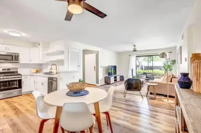 a kitchen and living room with a table and chairs at Resort Living with Pool & Tennis Minutes to Del Mar Beaches in San Diego