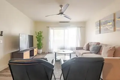 a living room with a couch and a tv at Resort Living with Pool & Tennis Minutes to Del Mar Beaches in San Diego