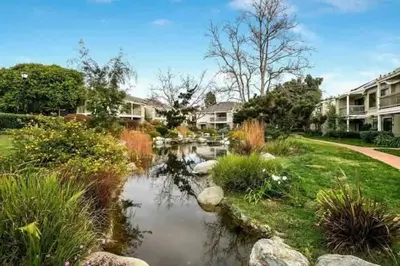 a small pond in a yard with houses at Resort Living with Pool & Tennis Minutes to Del Mar Beaches in San Diego
