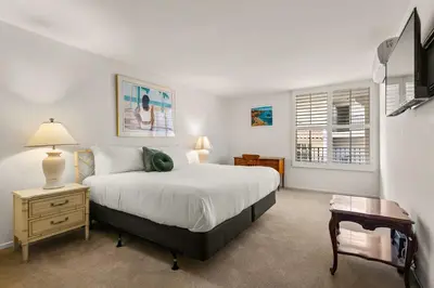a bedroom with a bed and a table and a chair at Waterfront Condo Unmatched Views and Prime Location in San Diego
