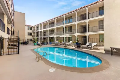 a swimming pool in the courtyard of a apartment building at Waterfront Condo Unmatched Views and Prime Location in San Diego