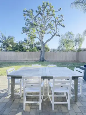 a white table with white chairs and a tree at Del Mar Coastal Haven in San Diego