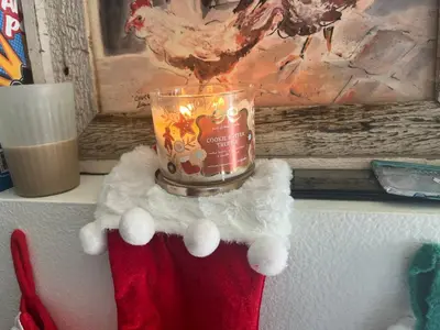 a candle sitting on top of a shelf with a santa hat at Private stay SD in San Diego