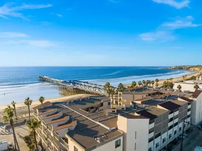 an aerial view of the beach and a pier at Penthouse at Pacific Beach Crystal Pier in San Diego