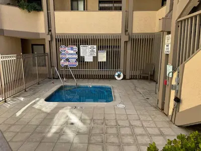 a small swimming pool in a courtyard of a building at Penthouse at Pacific Beach Crystal Pier in San Diego