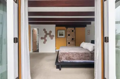 a bedroom with a bed and an open doorway at Boho-Style Point Loma Retreat Large Outdoor Deck in San Diego