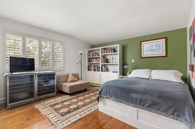 a bedroom with a bed and a flat screen tv at Boho-Style Point Loma Retreat Large Outdoor Deck in San Diego
