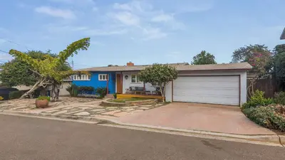 a house with a garage in front of it at Boho-Style Point Loma Retreat Large Outdoor Deck in San Diego