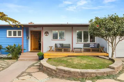 a house with two benches on the front porch at Boho-Style Point Loma Retreat Large Outdoor Deck in San Diego