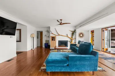 a living room with a blue couch and a tv at Boho-Style Point Loma Retreat Large Outdoor Deck in San Diego