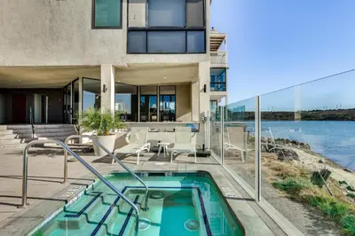 a house with a swimming pool next to a building at Waterfront Condo with Dock Access in Carlsbad! in Carlsbad