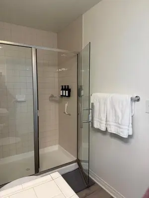 a bathroom with a shower with a glass shower stall at San Diego Skyline in San Diego
