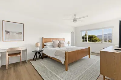 a white bedroom with a bed and a desk and a window at Modern Escape w Mountain Views, Walk to Lake, Golf, Resort, Dining in San Marcos