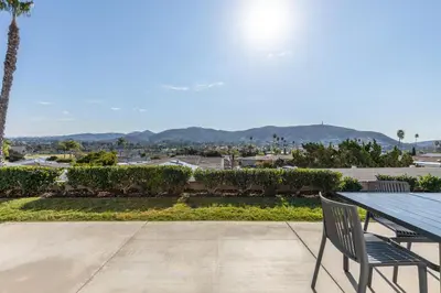 a table and chairs on a patio with a view at Modern Escape w Mountain Views, Walk to Lake, Golf, Resort, Dining in San Marcos