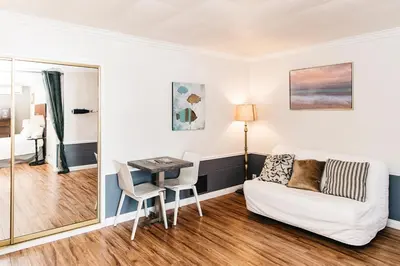a living room with a couch and a table at Laguna Cove Hotel in Laguna Beach
