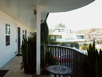 a balcony with a table and some plants at Laguna Cove Hotel in Laguna Beach