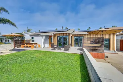 a house with a lawn in front of it at House Kitsune - Steps to Beach in Oceanside