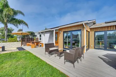 a house with a deck with chairs and a table at House Kitsune - Steps to Beach in Oceanside