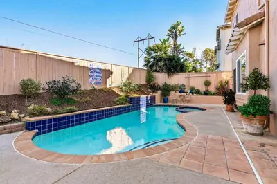 a swimming pool in a yard next to a fence at Encinitas Retreat Private Pool and Spa Short Drive to Beach in Encinitas