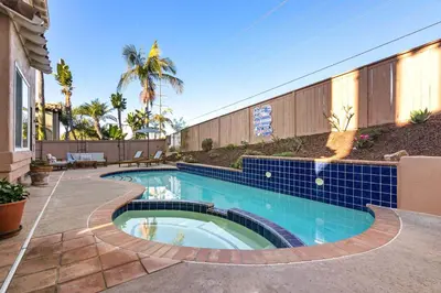 a swimming pool with blue tile around a house at Encinitas Retreat Private Pool and Spa Short Drive to Beach in Encinitas