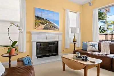 a living room with a couch and a fireplace at Encinitas Retreat Private Pool and Spa Short Drive to Beach in Encinitas