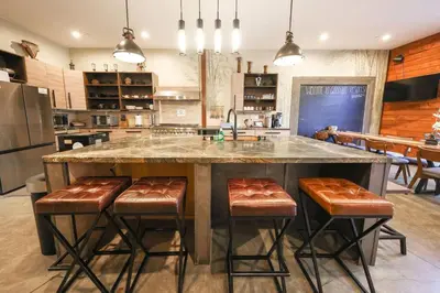 a kitchen with a large island with bar stools at Bamboo Loft 6BR, 24 guests in San Diego