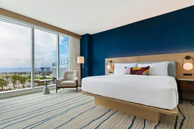 a bedroom with a large bed and a blue wall at Gaylord Pacific Resort & Convention Center in Chula Vista