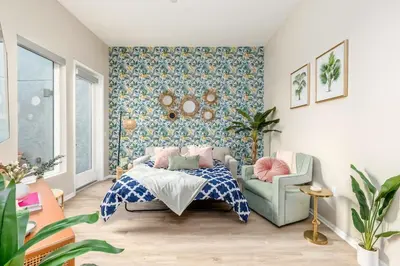 a bedroom with a bed and a chair at Eclectic Fast Wi-Fi Parking Pets Bohemian in San Diego