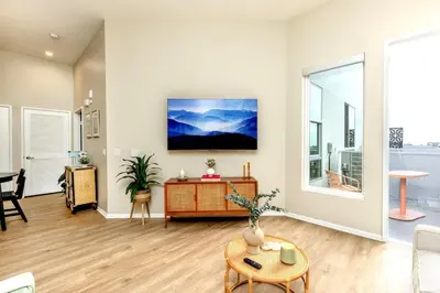 an empty living room with a table and a couch at Eclectic Fast Wi-Fi Parking Pets Bohemian in San Diego