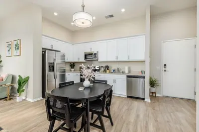 a kitchen and dining room with a table and chairs at Eclectic Fast Wi-Fi Parking Pets Bohemian in San Diego