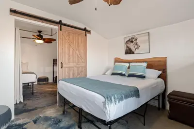 a bedroom with a bed with blue and white pillows at Next to Downtown Huge yard with Parking in San Diego