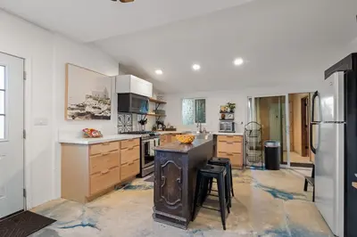 a kitchen with white walls and wooden cabinets and a refrigerator at Next to Downtown Huge yard with Parking in San Diego
