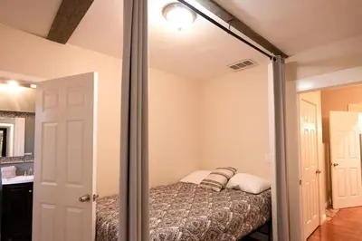 a small bedroom with a bed in a room at Historic 1910 House near downtown in San Diego