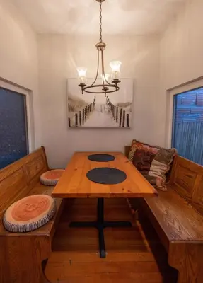 a dining room with a wooden table and a chandelier at Historic 1910 House near downtown in San Diego