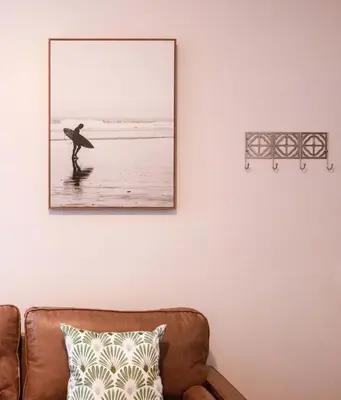 a picture of a man holding a surfboard on the beach at Historic 1910 House near downtown in San Diego