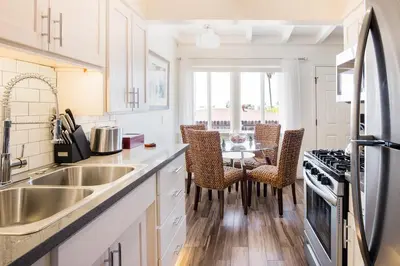 a kitchen with a sink and a table with chairs at Gorgeous Retreat Close to Beach and Downtown in San Clemente