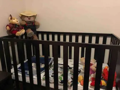 a crib with stuffed animals sitting on it at Entire Private Home with 3 Bedrooms, Gated Yard, Parking, King Bed, Available Now in Spring Valley