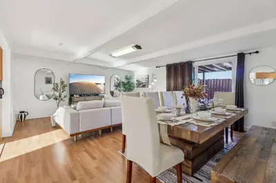 a dining room and living room with a table and chairs at Entire Private Home with 3 Bedrooms, Gated Yard, Parking, King Bed, Available Now in Spring Valley