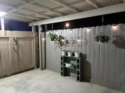 a garage with white fences and potted plants on a shelf at Haven Vibe in Escondido