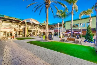 a shopping mall with palm trees in front of it at Cardiff View in Cardiff-by-the-Sea