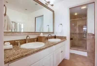 a bathroom with two sinks and a shower at Cardiff View in Cardiff-by-the-Sea