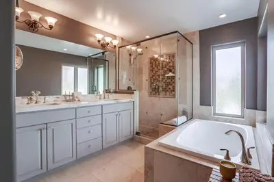 a bathroom with a large tub and a large mirror at Marine Dream in San Diego