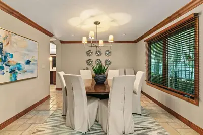 a dining room with a table and white chairs at Grand Retreat Rooftop Bliss and Ocean Views in San Diego