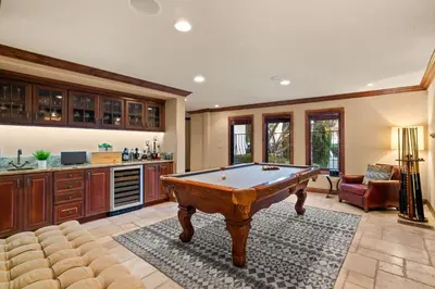a living room with a pool table in it at Grand Retreat Rooftop Bliss and Ocean Views in San Diego