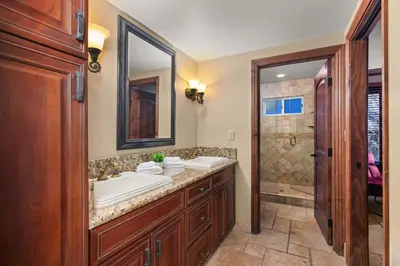 a bathroom with two sinks and a shower at Grand Retreat Rooftop Bliss and Ocean Views in San Diego